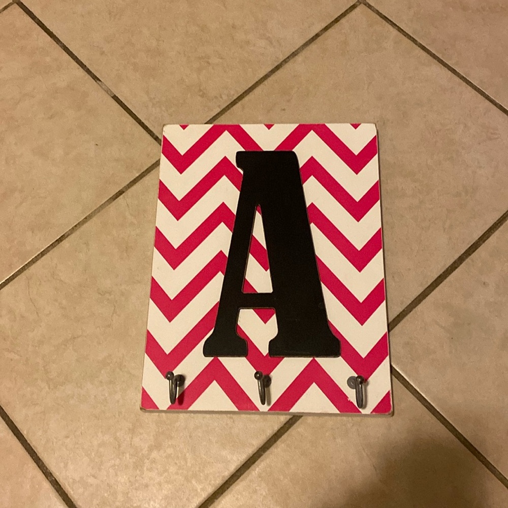 jewelers hanging board with 3 hooks and letter A on it